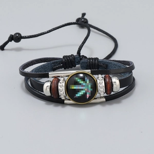 Detail of multilayer woven leather bracelet with wooden beads and maple leaf glass charm