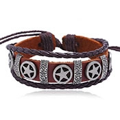 Macro shot of layered vintage leather bracelet with star alloy charms and braided cord