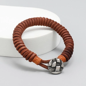 Retro handmade braided brown leather bracelet featuring a textured metal button clasp