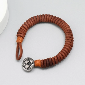 Handmade vintage brown leather braided bracelet with retro silver metal button closure