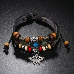Detail of multi-layer braided leather bracelet with blue bead and butterfly charm