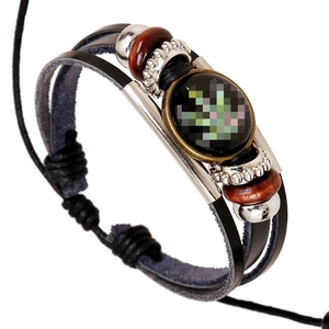 Multilayer braided leather bracelet with wooden beads and green leaf glass dome charm