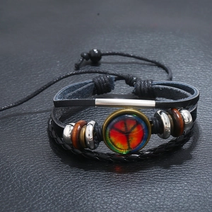 Multilayer leather bracelet with peace sign charm and wooden beads on black background