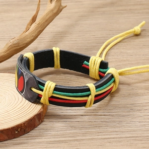 Detail of woven leather bracelet with red, yellow, and green braided wax cords