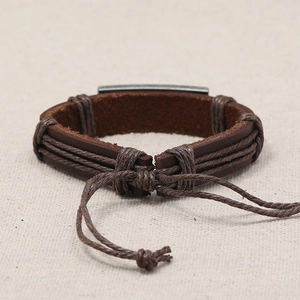 Close-up of World Peace vintage woven leather bracelet with adjustable cord closure