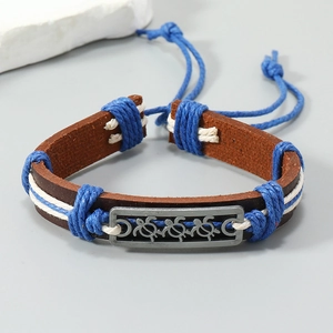 Detail view of handmade leather bracelet with turtle alloy plate and braided ropes