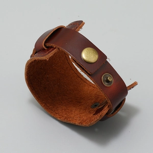 Detail of vintage brown multilayer leather cuff bracelet with bronze snap buttons