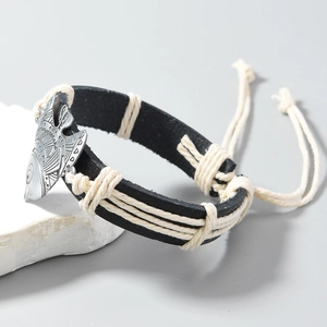 Detail of hand-woven PU leather bracelet with silver fish charm and white cord wrap