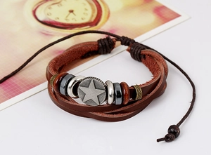 Detail of vintage multilayer brown leather bracelet featuring metal star and hematite beads