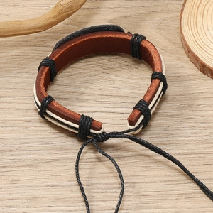 Detail of adjustable drawstring closure on retro hand-woven brown leather bracelet
