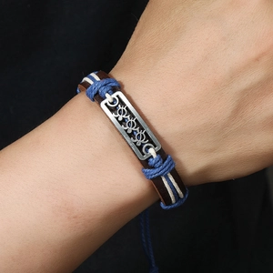 Handmade woven leather bracelet with antique silver turtle charms and blue cotton cord