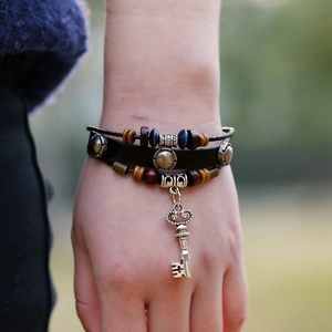 Bohemian multi-layer leather bracelet with blue beads and a vintage silver key charm