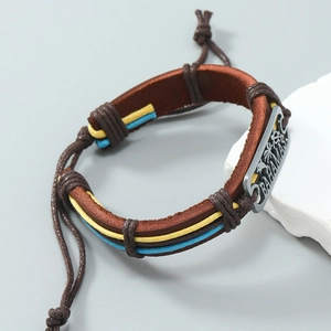 Close-up of leather bracelet with Bahamas engraving and tropical palm tree pattern