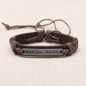 Detail of multi-layer braided leather bracelet with Are You Ready engraved metal plate