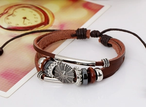 Detail of multilayer woven leather bracelet featuring a star-patterned alloy charm and beads