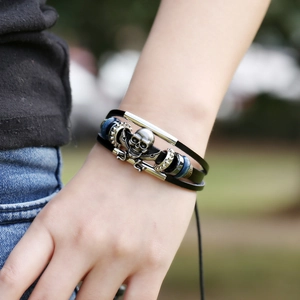 Multilayer leather bracelet with silver skull pirate charm and wooden beads on model