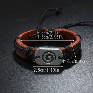Handmade vintage brown leather bracelet with an engraved spiral metal plaque