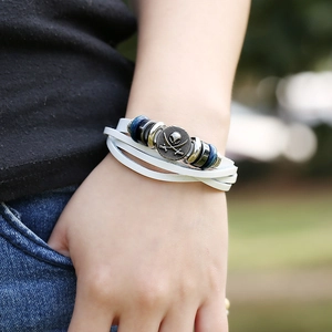 Multilayer leather wrap bracelet featuring pirate skull charms and wooden beads