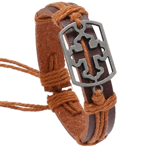 Brown braided leather bracelet with a metal cross and adjustable hemp rope strings