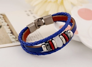 Detail of blue multilayer braided leather bracelet with silver beads and metal buckle