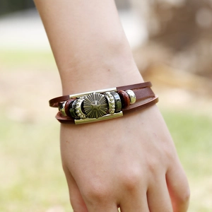 Multilayer brown leather bracelet with star metal relief and wood beads worn on wrist