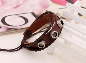 Detail view of vintage brown leather bracelet with industrial silver hex nut accents