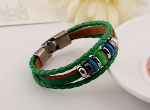 Detailed shot of green multi-layer braided leather bracelet with vintage metal clasp