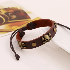 Bracelet en cuir marron tressé avec crâne en bronze et cordon réglable vintage
