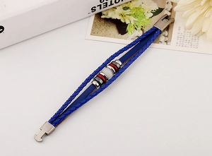 Detail of blue braided leather bracelet with silver metal beads and a white accent stone