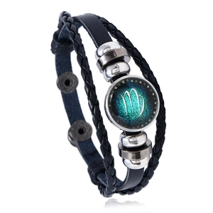 Macro shot of Virgo zodiac leather bracelet with glass charm and metal bead detailing