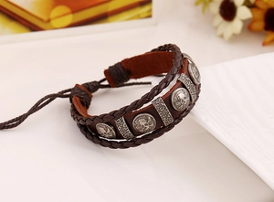 Detail of dark brown braided leather bracelet with skull rivets and adjustable cord