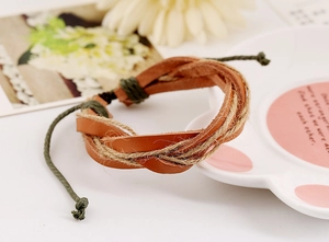 Detail view of handmade braided leather and hemp rope bracelet with adjustable cord