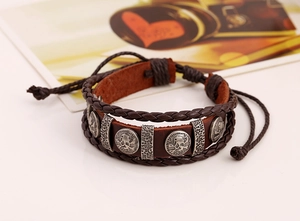 Detail of vintage punk leather bracelet featuring skull charms and woven cords