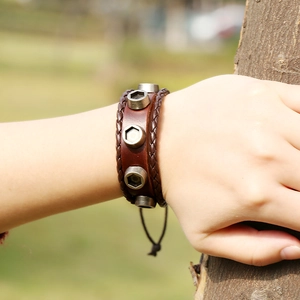 Men's vintage brown leather bracelet with industrial metal nuts and woven details