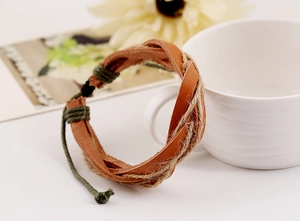 Detail of hand-woven vintage leather bracelet with brown leather and green hemp rope