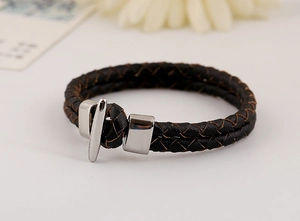 Detailed close-up of double-layer woven PU leather bracelet with silver metal clasp