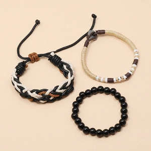 Three-piece bohemian braided rope and black beaded bracelet set for men on beige background