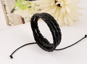 Detail of multi-layer black braided leather bracelet with adjustable drawstring closure