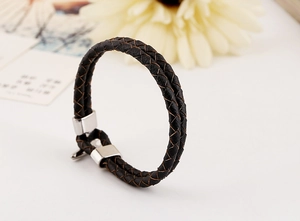 Detail of double-strand braided PU leather bracelet with silver metallic fastener