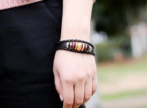 Close-up of multilayer braided leather bracelet with marble bead on a male wrist