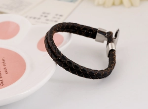 Close-up of dark brown double-strand braided PU leather bracelet with silver anchor hook