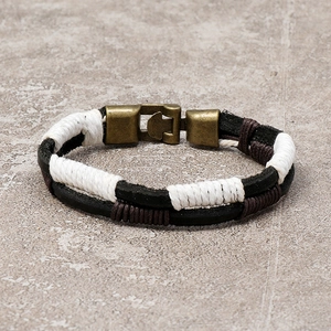 Close-up of multilayer braided leather cord bracelet with antique bronze metal clasp