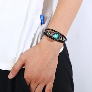 Detail of Libra zodiac leather bracelet with braided cord and vintage metal beads