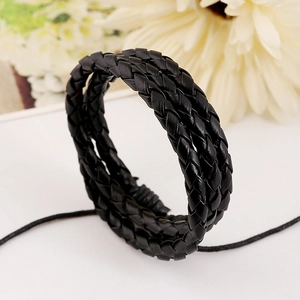Handmade black multi-layer braided leather bracelet for men and women on white surface