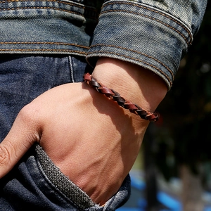 Bracciale in pelle intrecciata da uomo nei toni del marrone e marrone scuro sul polso
