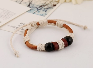 Close-up of woven leather bracelet with wooden beads and adjustable sliding knot