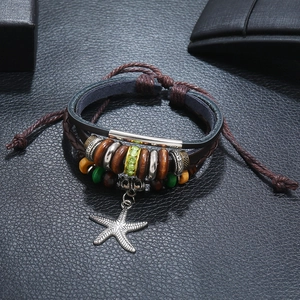 Bohemian multilayer leather bracelet featuring wooden beads and a silver starfish charm