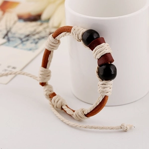 Handcrafted woven brown leather bracelet with white cotton cord and black wooden beads