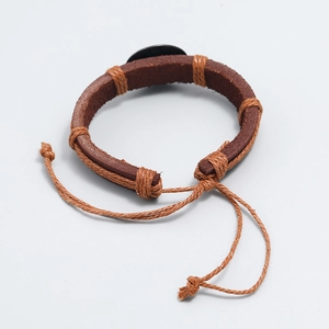 Detail of vintage braided dark brown leather bracelet with adjustable rope closure