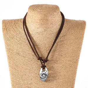 Vintage long leather necklace for men featuring a silver oval pendant with spiral engraving